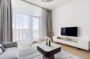 Design Apartment, Balcony, City View | Living area | 50-inch LED TV with digital channels