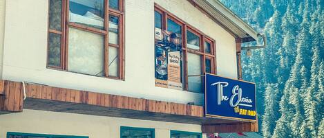 A two-story building with a sign for "The Elvea" and "Fat Dad" restaurant.