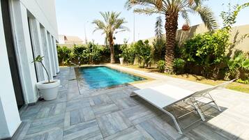 Outdoor pool, open 8:00 AM to 5:00 PM, pool umbrellas