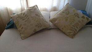 A bed with two pillows, a blue blanket, and a window with sheer curtains. - Comfortable Family room with Tv, Free Fast Wifi, Sleeps 3 (Hayes)