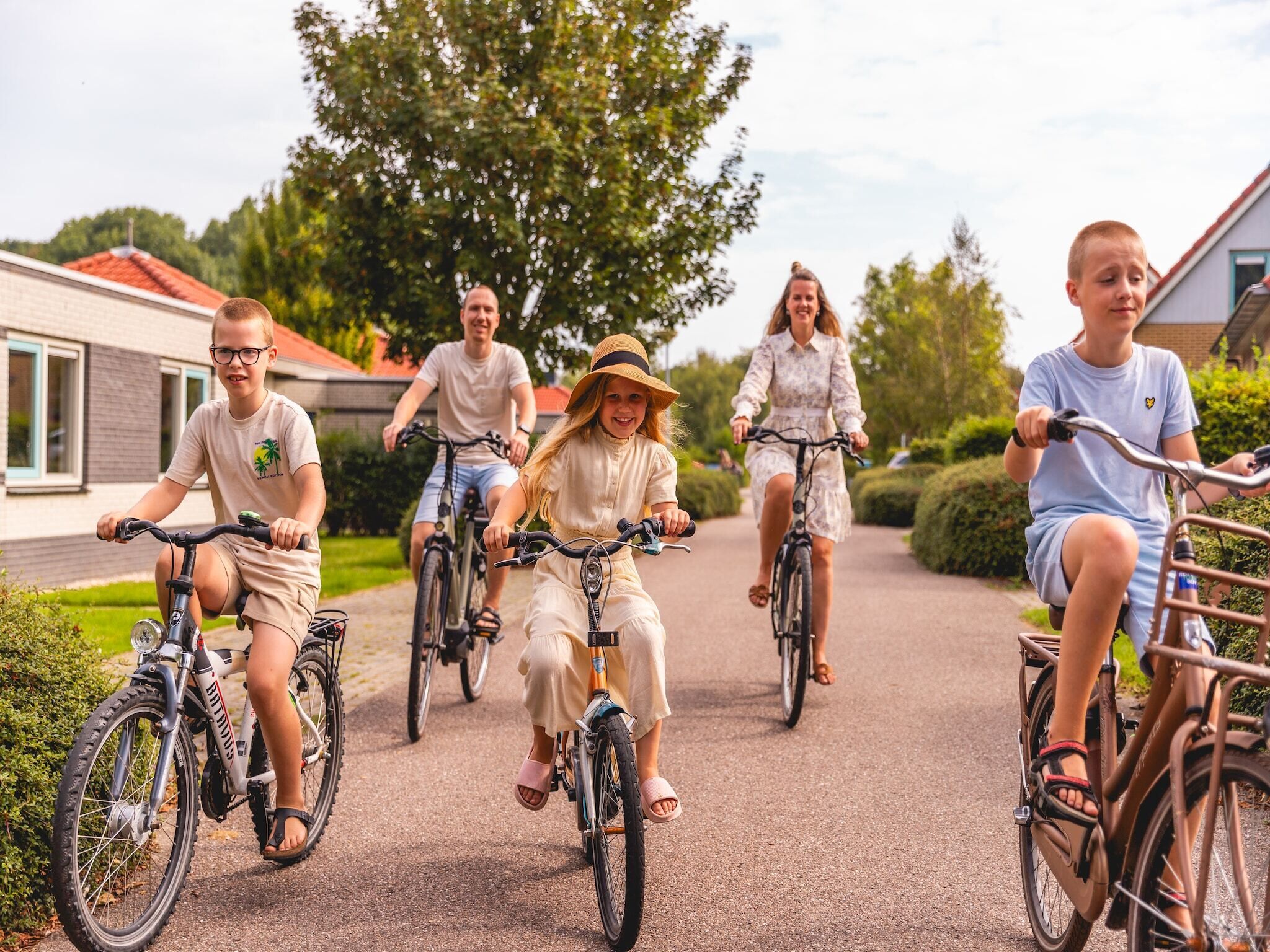 A group of people riding bicycles on a paved path.