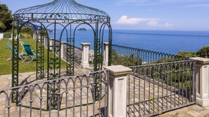 A gazebo with a metal roof overlooking a coastal view. - Our Dream by Interhome (Alassio)