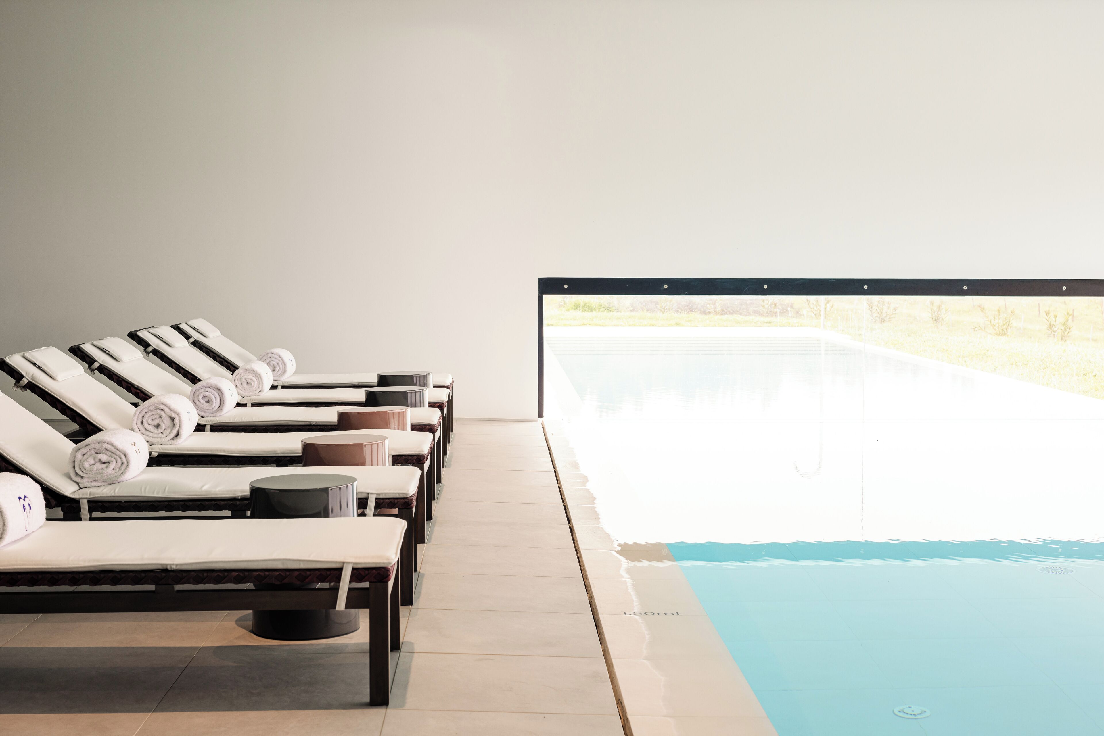 A poolside area with lounge chairs and a view of the pool.