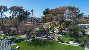 A landscaped garden with a circular seating area, pathways, and trees. - 15,000 sqft Mansion 5 min from strip! 1.5 acre compound.  (Las Vegas)