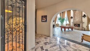 A spacious lobby with a marble floor, a pool table, and a fireplace. - 15,000 sqft Mansion 5 min from strip! 1.5 acre compound.  (Las Vegas)
