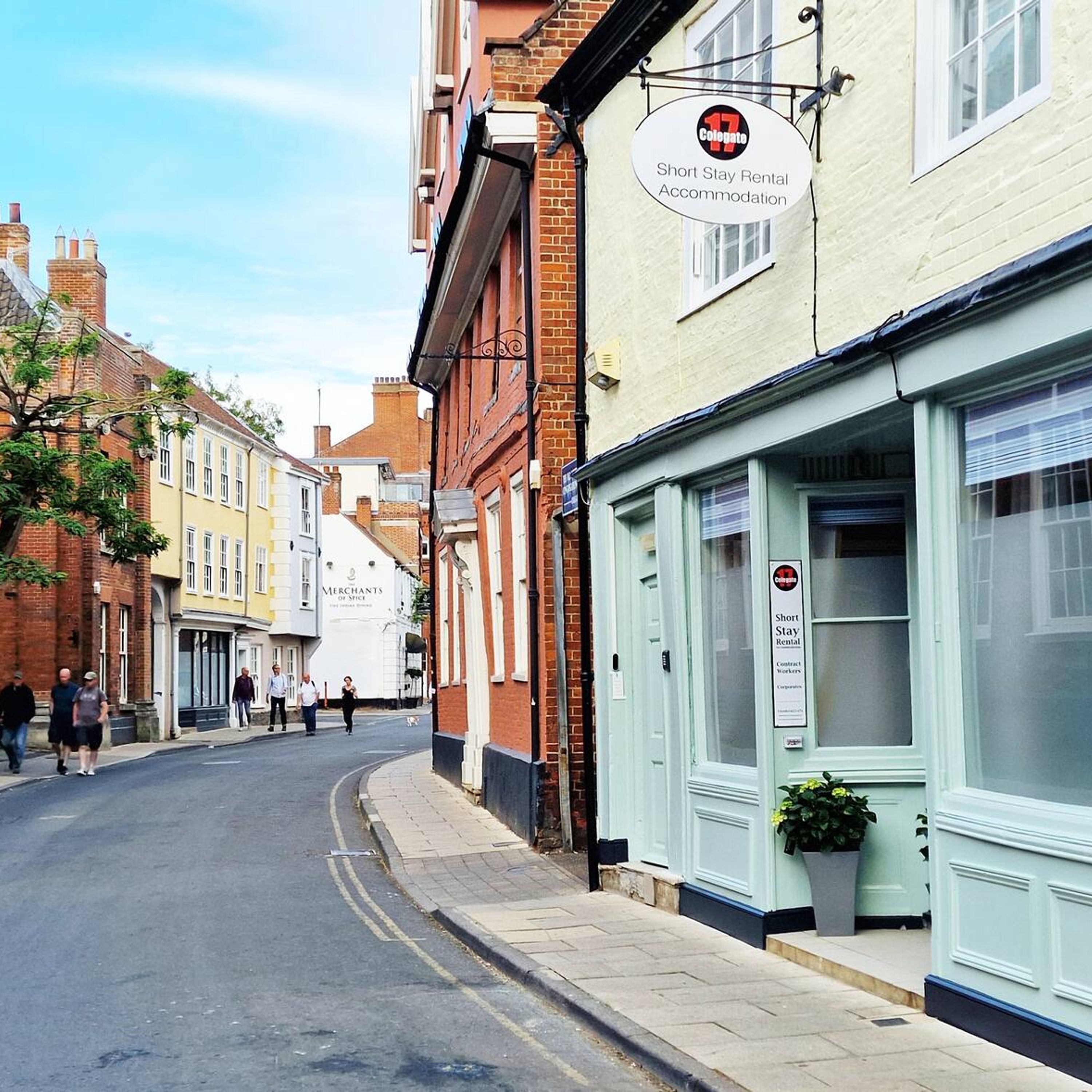 A street view with a building labeled 'Short Stay Rental Accommodation' and 'Merchants of Spice'.