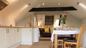 A cozy loft apartment with a kitchen, dining area, and living space.