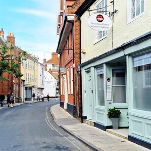 A street view with a building labeled 'Short Stay Rental Accommodation' and 'Merchants of Spice'.