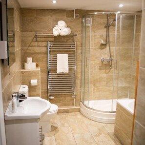 A modern bathroom with a glass-enclosed shower, a white sink, and a toilet. - Stay Norwich Apartments Lodge 5 (Norwich)