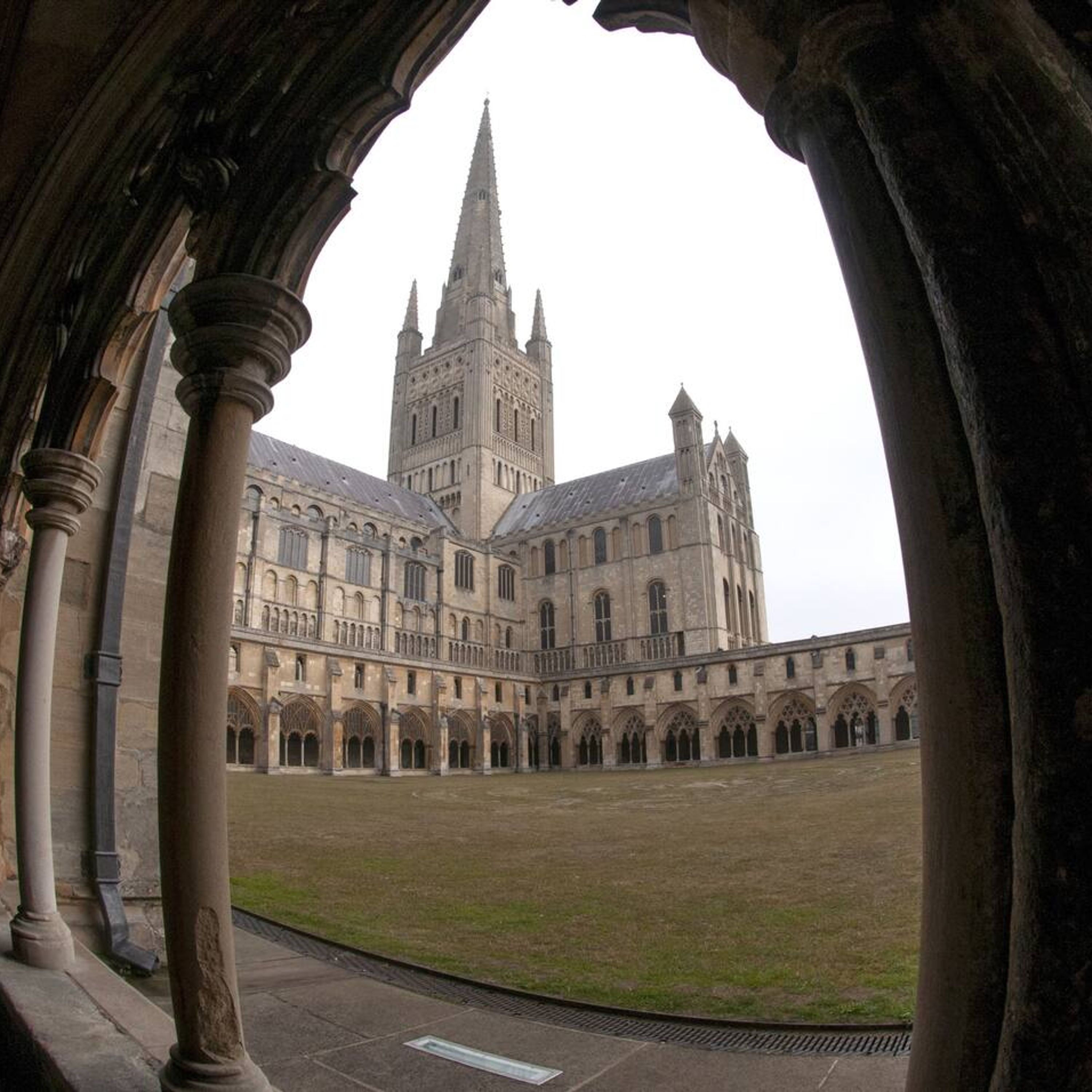 A large historic building with a central tower and multiple arches.
