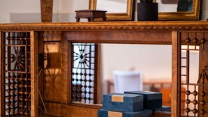 A wooden display with a window, a decorative metal piece, and two blue boxes. - Victorian Estates | Sun Soaked 1BR | Close to CCF (Cleveland)