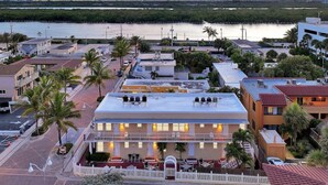 A hotel with a rooftop bar, multiple floors, and a view of the water. - American Dream Just Steps to the Beach (Hollywood)