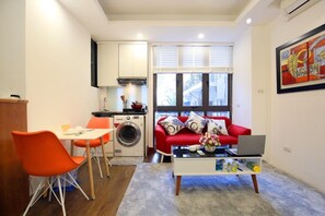 Basic Apartment, City View | Living area | 55-inch TV with cable channels, fireplace, heated floors - Sumitomo 2 - 12 Dao Tan (Hanoi)