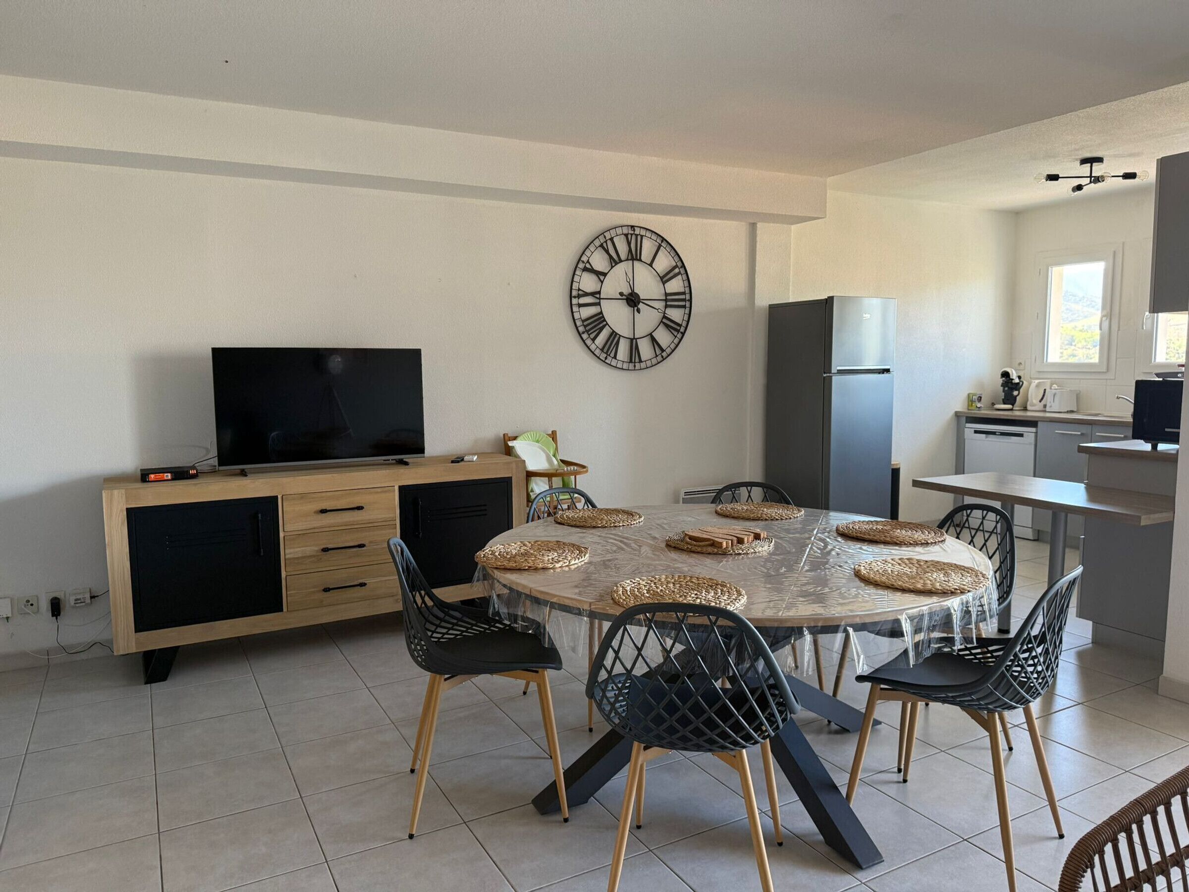 A modern kitchen with a dining area.