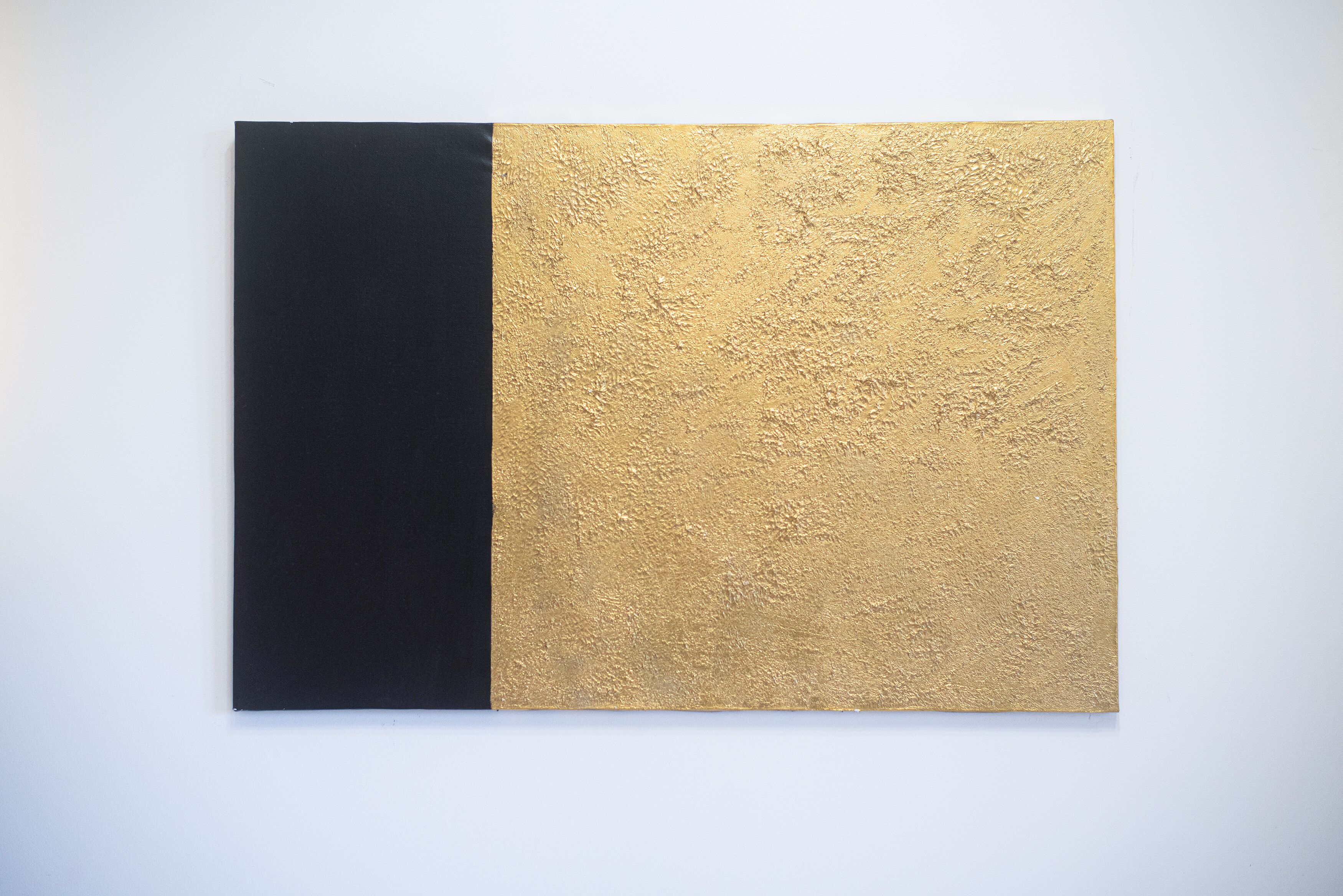 A black and gold textured wall.