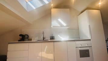 Fridge, coffee/tea maker, cookware/dishes/utensils, dining tables