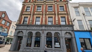 A historic building with ornate architectural details, including columns and decorative moldings. - Penthouse-highstreet-sleeps2-87ws (Merthyr Tydfil)