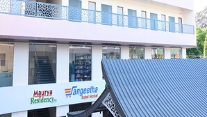 A two-story building with a sign reading "Sangeetha Super Market" on the ground floor. - Maurya Residency (Gingee)