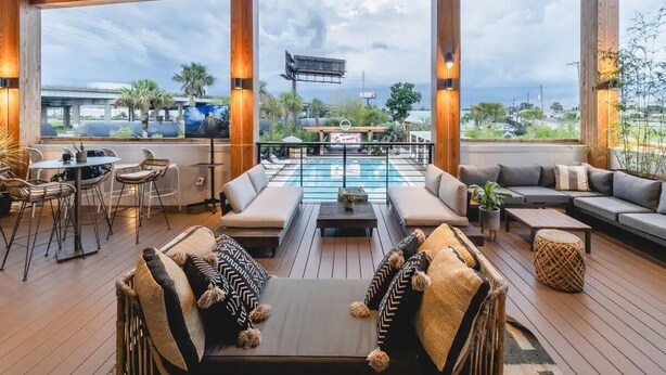 A spacious outdoor area with a pool, seating arrangements, and a view of the surrounding landscape. - The King Suites at 493 - 8 Suites, 16 Bedrooms (Charleston)