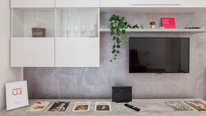 A modern kitchen with white cabinetry, a built-in TV, and a coffee machine. - La casa di Lorenzo by Wonderful Italy (Genoa)