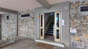 A stone building with a numbered door, a staircase, and a sign indicating a public housing condominium. - La casa di Lorenzo by Wonderful Italy (Genoa)