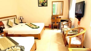 A hotel room with a bed, a desk, a chair, and a television. - Viet Thai Hotel (Bac Hong Linh)