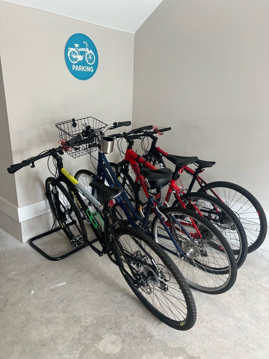 Bicycles parked in a designated area with a sign indicating parking.