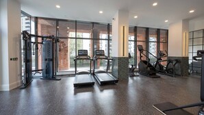 A modern gym with treadmills, elliptical machines, and weightlifting equipment. - Organika Suite & 2BR Luxury w/ Skyline Views & Gym Access! (Greater Manchester)