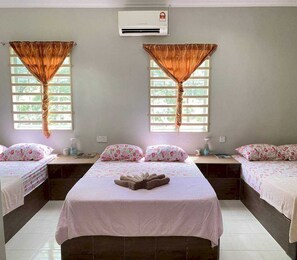 A hotel room with two beds, a large window with curtains, an air conditioning unit, and a bedside table with a lamp. - Hotel O D Qamar Motel (Langkawi)