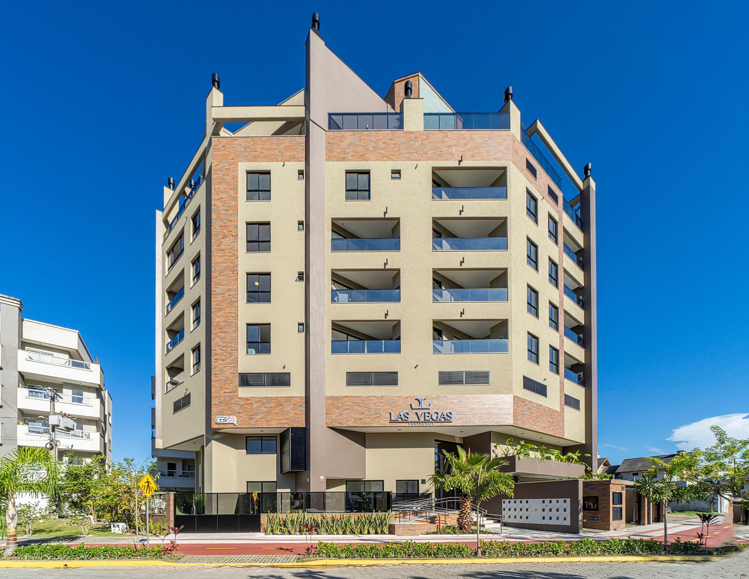 A multi-story hotel with a modern design, featuring balconies and a prominent entrance.