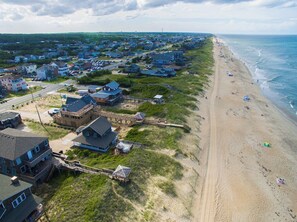 A coastal residential area with houses and a beach.