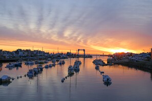 Stunning harbor views with boats docked in calm waters, surrounded by buildings.