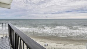 A beach view from a balcony with a railing, ocean waves, and a cloudy sky. - Royal Garden Unit 609 -  2 Bedroom, 2 Bath Oceanfront Condo (Garden City Beach)