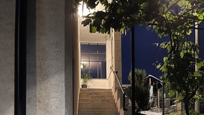 Eine Treppe führt zu einem Gebäudeeingang in der Nacht.