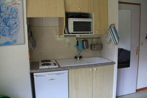 Een koelkast, een oven, een kookplaat, een koffiezetapparaat/waterkoker