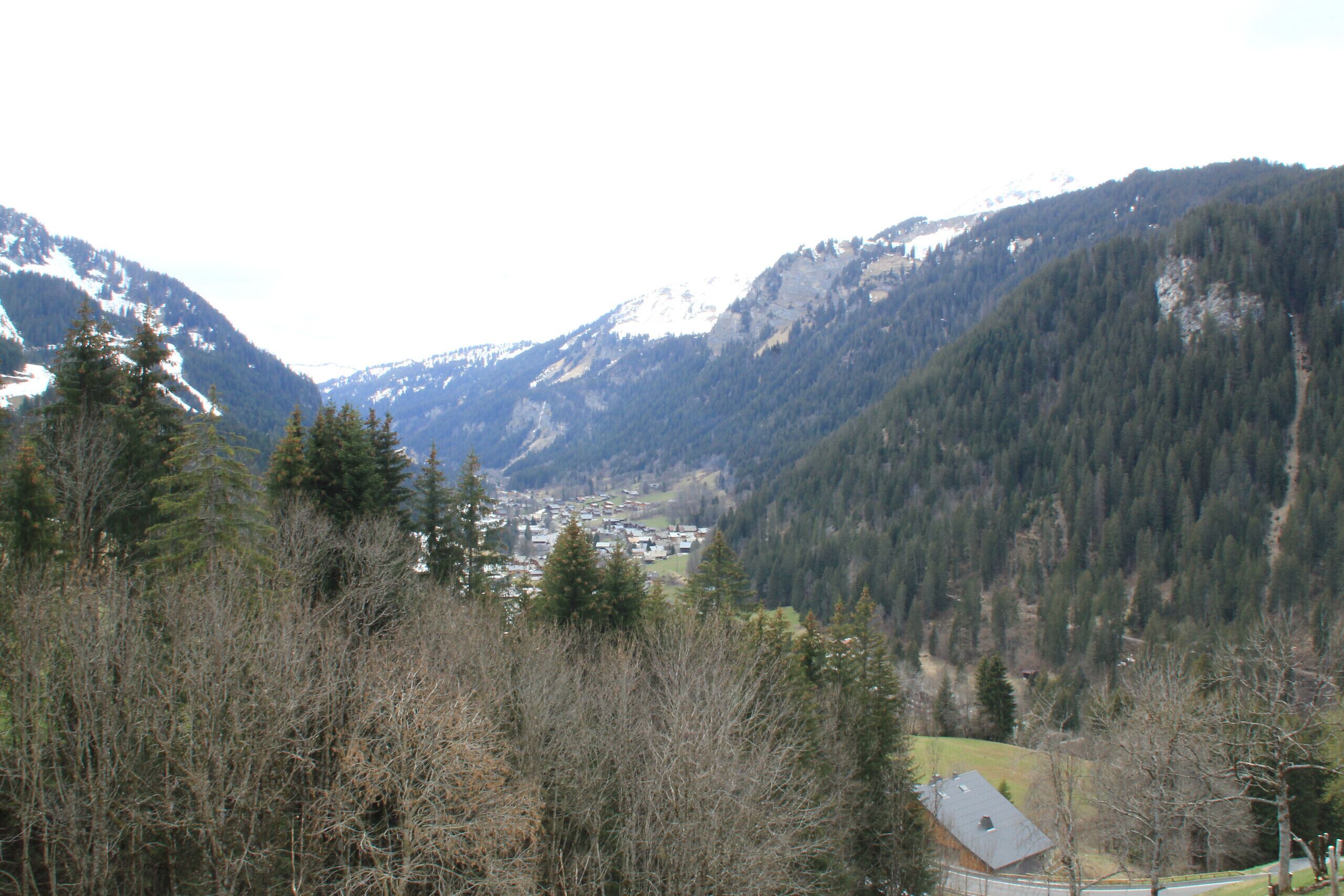 A mountainous landscape with a small village nestled in a valley.