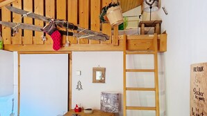 A cozy room with a loft bed, wooden ceiling, and a small desk with a lamp. - Forsythia FA18 FAMILY 1& NATURE 4 Pers. (Châtel)