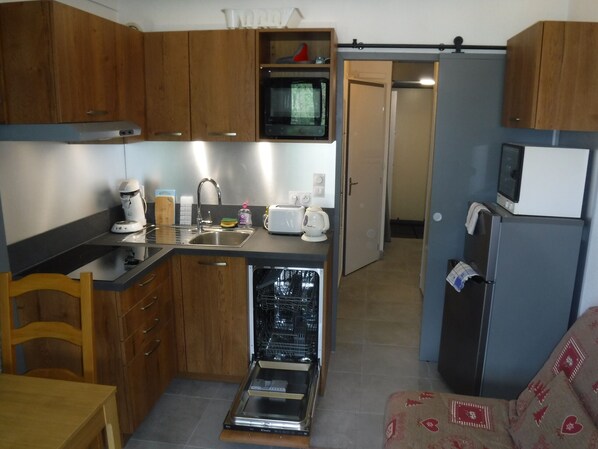 Enjoy cooking in this kitchen with a dishwasher, microwave, and wooden cabinets.