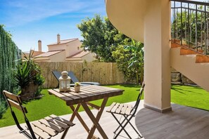 A patio with a wooden table and chairs, a small potted plant, and a lantern. - Riviera del Sol rooftop by Costarentals - Ref 45 (Urbanización Riviera Sol)