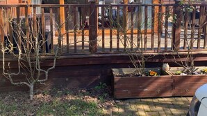 A wooden gazebo with a covered deck, surrounded by a wooden fence and a brick pathway. - Relaxing Lodge In The Heart Of Northumberland (Felton)
