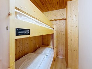 A bunk bed room with a sign indicating it is not suitable for children under six years old.