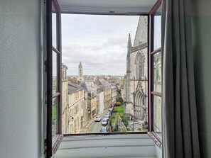A view from a window with a view of a cityscape, including buildings and a church. - Superb apartment - heart of old town - Cathedral view (Vannes)