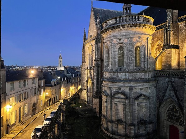 A historic building with a prominent tower and a circular structure with ornate detailing.