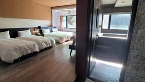 A hotel room with two beds, a large window, and a view of the outside. - Xiang Ting (Nantou)