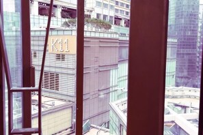 A high-rise building with a sign reading 'K11' and a view of other buildings.