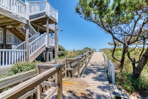 Stroll along the boardwalk to this resort, featuring multiple levels with white railings.