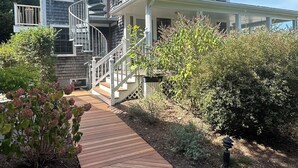 A two-story house with a wooden deck leading to a front porch. - Ptown Paradise Farmhouse in the perfect, central location! (Provincetown)