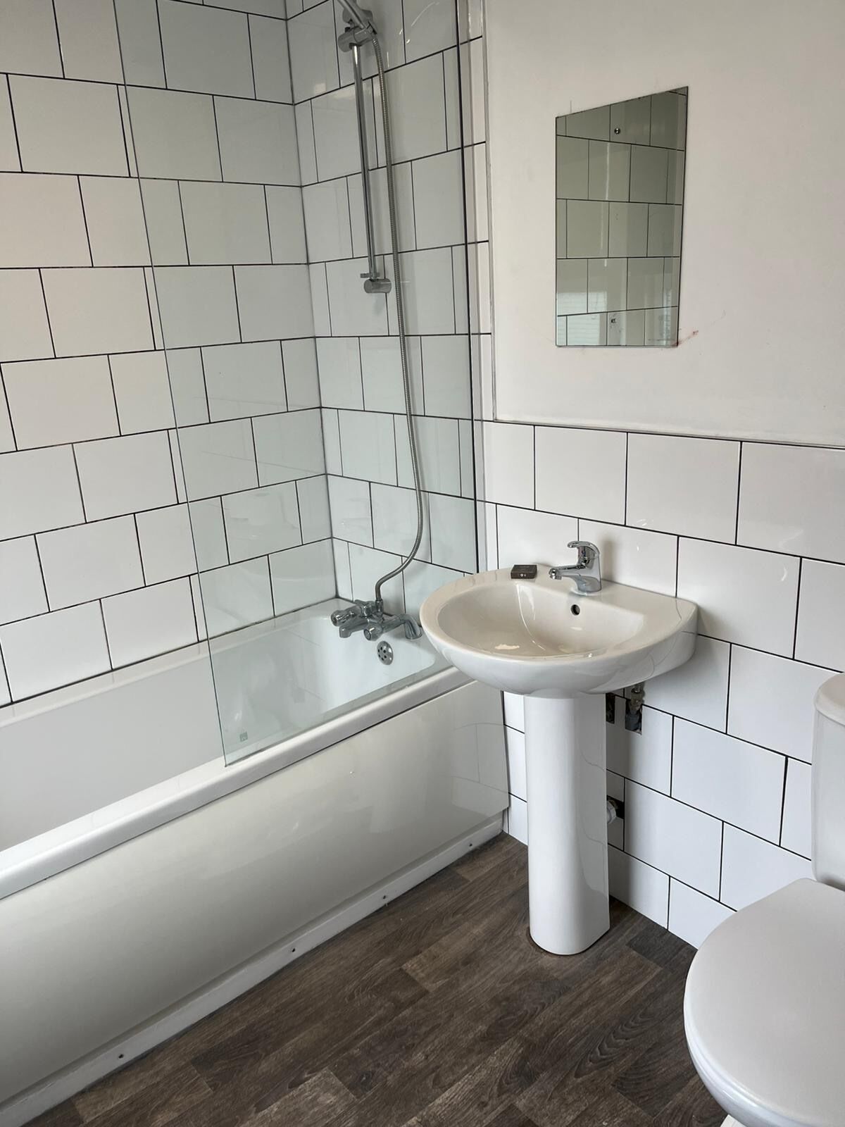 Un baño con una bañera blanca, un lavamanos y un inodoro.