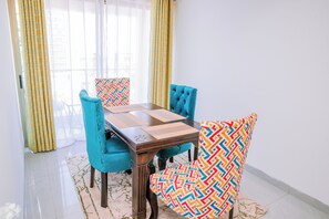 Enjoy meals in this dining area with a rectangular table and four chairs, each featuring a geometric-patterned cushion.