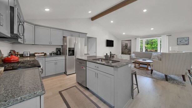 A modern kitchen with granite countertops, stainless steel appliances, and a central island. - Modern Home on Sand Point! 11 mins to DT caseville (Caseville)